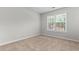 This bedroom has a window overlooking the property and neutral walls to match any decor at 6416 Chestnut Glen Dr, Norcross, GA 30071