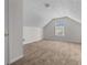 Bedroom featuring neutral carpet, white walls, a large window and vaulted ceiling at 6416 Chestnut Glen Dr, Norcross, GA 30071