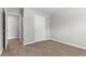 This bedroom has neutral walls and carpeting plus a door to another room that makes the space feel larger at 6416 Chestnut Glen Dr, Norcross, GA 30071