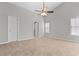 This primary bedroom has vaulted ceiling with fan and large windows that provide a view and plenty of natural light at 6416 Chestnut Glen Dr, Norcross, GA 30071
