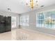 Bright breakfast nook featuring tiled flooring, a golden chandelier, and abundant natural light from large windows at 6416 Chestnut Glen Dr, Norcross, GA 30071