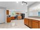 Open kitchen featuring tile floors, wooden cabinets, stainless steel appliances, and modern lighting at 6416 Chestnut Glen Dr, Norcross, GA 30071