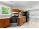 Spacious kitchen with wooden cabinets, stainless steel appliances, and tiled floors at 6416 Chestnut Glen Dr, Norcross, GA 30071