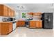 Well-equipped kitchen with wooden cabinets, stainless steel appliances, and tiled flooring at 6416 Chestnut Glen Dr, Norcross, GA 30071