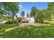 A backyard features a lawn, pool, wooden deck, white home exterior, and a wooden fence surrounding the property at 664 Somerset Dr, Lawrenceville, GA 30046