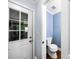Small bathroom features a toilet and view of the backyard through a door at 664 Somerset Dr, Lawrenceville, GA 30046