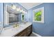 Bathroom featuring double sinks, modern lighting, and a stylish mirror with plenty of counter space at 664 Somerset Dr, Lawrenceville, GA 30046