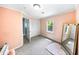 Bedroom featuring light pink walls, a closet, and large framed mirror at 664 Somerset Dr, Lawrenceville, GA 30046