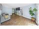 Comfortable living area featuring hardwood floors, a gray sofa, and a leafy fig plant at 664 Somerset Dr, Lawrenceville, GA 30046
