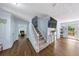 Open living space with a fireplace, hardwood floors, and natural light from the nearby French doors at 664 Somerset Dr, Lawrenceville, GA 30046