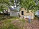 Backyard with small detached garage with open door and concrete steps at 712 Garibaldi Sw St, Atlanta, GA 30310