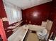 Outdated bathroom features a tub, toilet, and window, requiring a complete renovation at 712 Garibaldi Sw St, Atlanta, GA 30310