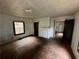 Spacious living room featuring hardwood floors, fireplace, and three doorways that fill the space with natural light at 712 Garibaldi Sw St, Atlanta, GA 30310