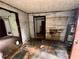 Room with damaged floor and walls, requiring a complete renovation, with water heater at 712 Garibaldi Sw St, Atlanta, GA 30310