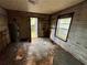 Room with damaged floor, walls, and ceiling featuring access to the outdoors at 712 Garibaldi Sw St, Atlanta, GA 30310