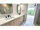 A luxurious bathroom featuring a glass shower, marble floors, double vanity, and modern fixtures at 105 Georgia Se Ave # 6, Atlanta, GA 30312