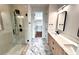 A luxurious bathroom featuring a glass shower, marble floors, double vanity, and modern fixtures at 105 Georgia Se Ave # 6, Atlanta, GA 30312