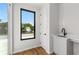 A view of the hallway leading to the patio with hardwood floors and utility sink at 105 Georgia Se Ave # 6, Atlanta, GA 30312