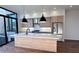 Modern kitchen with marble countertops, wooden cabinets, stainless steel appliances, and black pendant lights at 105 Georgia Se Ave # 6, Atlanta, GA 30312
