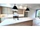 This is a kitchen with wood grain cabinets, stainless steel appliances and a large white countertop island at 105 Georgia Se Ave # 6, Atlanta, GA 30312