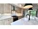 This is a kitchen with wood grain cabinets, stainless steel appliances and a large white countertop island at 105 Georgia Se Ave # 6, Atlanta, GA 30312
