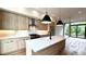 This is a kitchen with wood grain cabinets, stainless steel appliances and a large white countertop island at 105 Georgia Se Ave # 6, Atlanta, GA 30312