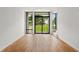 Bright living room boasts hardwood floors and expansive windows overlooking a serene backyard, offering a seamless indoor-outdoor living experience at 105 Georgia Se Ave # 6, Atlanta, GA 30312