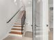 Modern staircase features hardwood steps, metal railings, and ample natural light, creating an inviting and stylish entryway at 105 Georgia Se Ave # 6, Atlanta, GA 30312