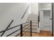 A view of the stairway with metal railing and natural wood treads at 105 Georgia Se Ave # 6, Atlanta, GA 30312