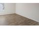 Spacious bedroom with a large window offering natural light, and beautiful hardwood flooring at 165 Twin Lakes Dr, Covington, GA 30016