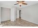 Charming bedroom with a ceiling fan, a walk-in closet, and an open doorway to the en suite bathroom at 165 Twin Lakes Dr, Covington, GA 30016