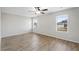 A bedroom with light walls, ceiling fan, and wood-look flooring at 165 Twin Lakes Dr, Covington, GA 30016