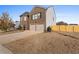 Side view of a two-story brick home with a two car garage and fenced backyard at 165 Twin Lakes Dr, Covington, GA 30016