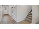 A bright foyer with neutral paint, wood floors, and carpeted stairs at 165 Twin Lakes Dr, Covington, GA 30016