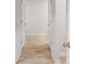 Hallway with wood floors, white walls, and access to rooms through white doors at 165 Twin Lakes Dr, Covington, GA 30016
