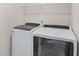 Laundry area with washer, dryer, and wire shelving for storage at 165 Twin Lakes Dr, Covington, GA 30016