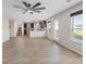 Open concept living space offers wood-look floors, many windows, kitchen and staircase at 165 Twin Lakes Dr, Covington, GA 30016