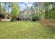 Expansive backyard with lush green grass, a large deck, and mature trees at 4635 Rutledge Dr, Snellville, GA 30039