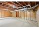 Unfinished basement showcasing exposed beams, a concrete floor, and the potential for customization at 4635 Rutledge Dr, Snellville, GA 30039