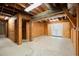 Unfinished basement with concrete floors, wood framing and a door to the exterior at 4635 Rutledge Dr, Snellville, GA 30039