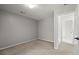 Simple bedroom featuring neutral walls and carpet with door to adjoining room at 4635 Rutledge Dr, Snellville, GA 30039