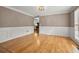 Dining room with hardwood floors, decorative wainscoting, and a modern light fixture at 4635 Rutledge Dr, Snellville, GA 30039