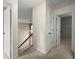 Upstairs hallway featuring neutral walls, carpet, and white doors leading to various rooms at 4635 Rutledge Dr, Snellville, GA 30039
