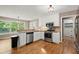 Well-lit kitchen featuring stainless steel appliances, granite countertops and ample cabinet space at 4635 Rutledge Dr, Snellville, GA 30039