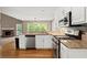 Open concept kitchen features stainless appliances, granite counters and hardwood flooring at 4635 Rutledge Dr, Snellville, GA 30039