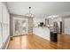 Eat-in kitchen with white cabinets, granite countertops, stainless steel appliances and hardwood flooring at 4635 Rutledge Dr, Snellville, GA 30039