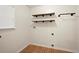Functional laundry room with wood floors and built-in shelves for added storage at 4635 Rutledge Dr, Snellville, GA 30039