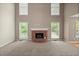 Spacious living room with a brick fireplace and plenty of natural light from the windows at 4635 Rutledge Dr, Snellville, GA 30039