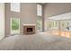 Bright living room with tall ceilings, a brick fireplace and a view of the backyard at 4635 Rutledge Dr, Snellville, GA 30039