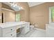 Well-lit main bathroom with a white vanity, mirror, and toilet, offering a clean and simple design at 4635 Rutledge Dr, Snellville, GA 30039